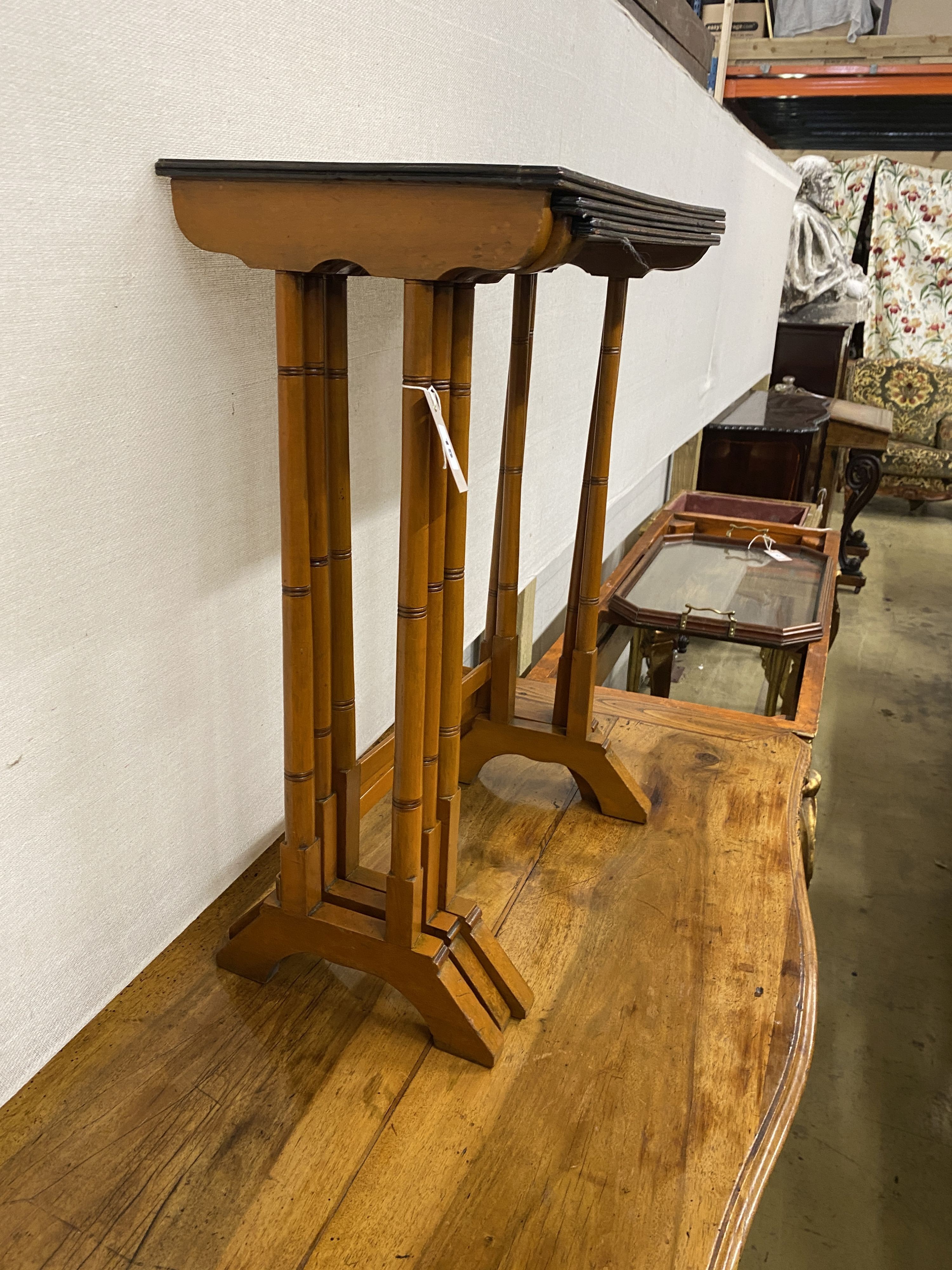 A nest of three mahogany and bird's eye maple rectangular tea tables, width 50cm, depth 30cm, height 69cm